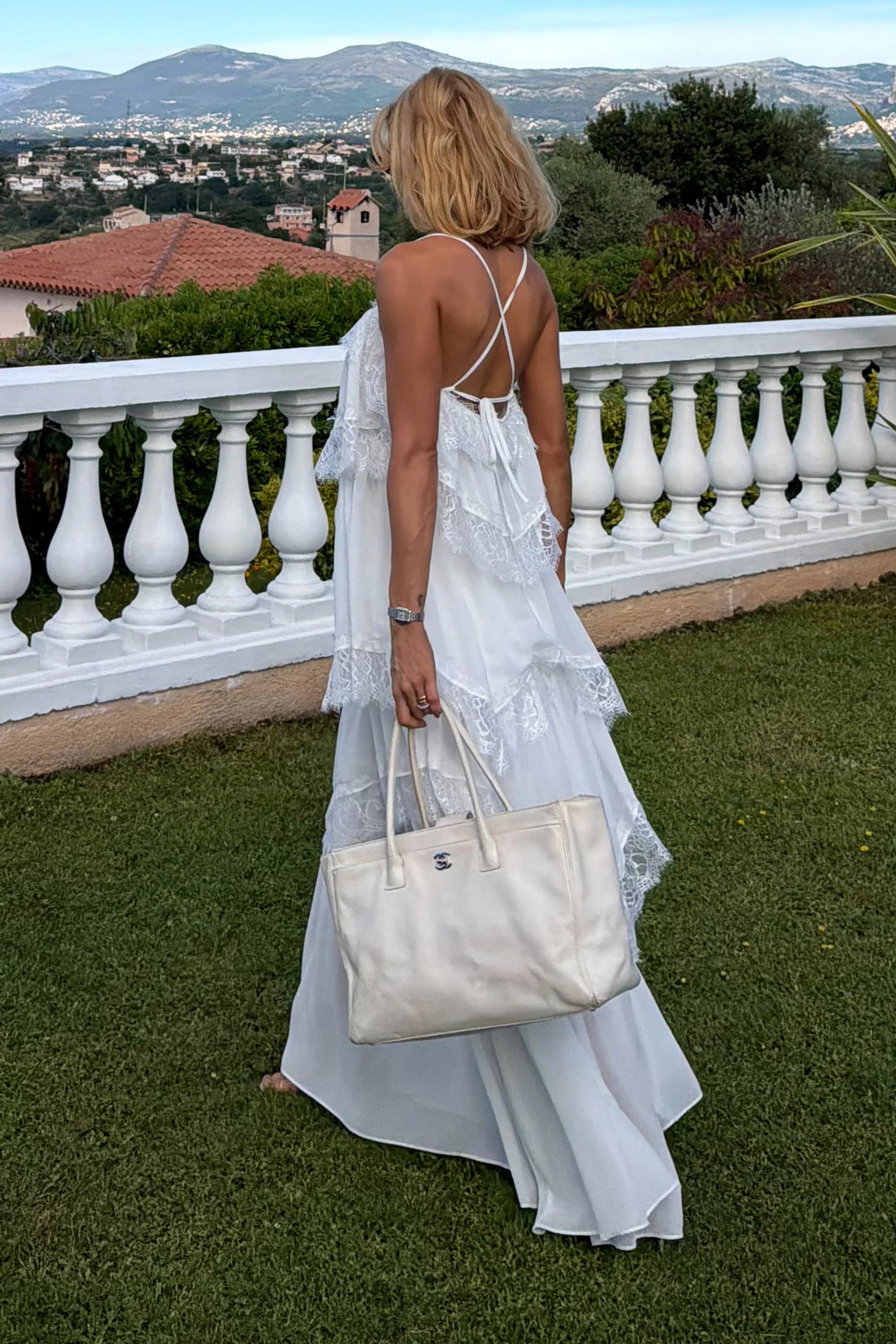 Off-white midi dress with ruffles and lace hem detail