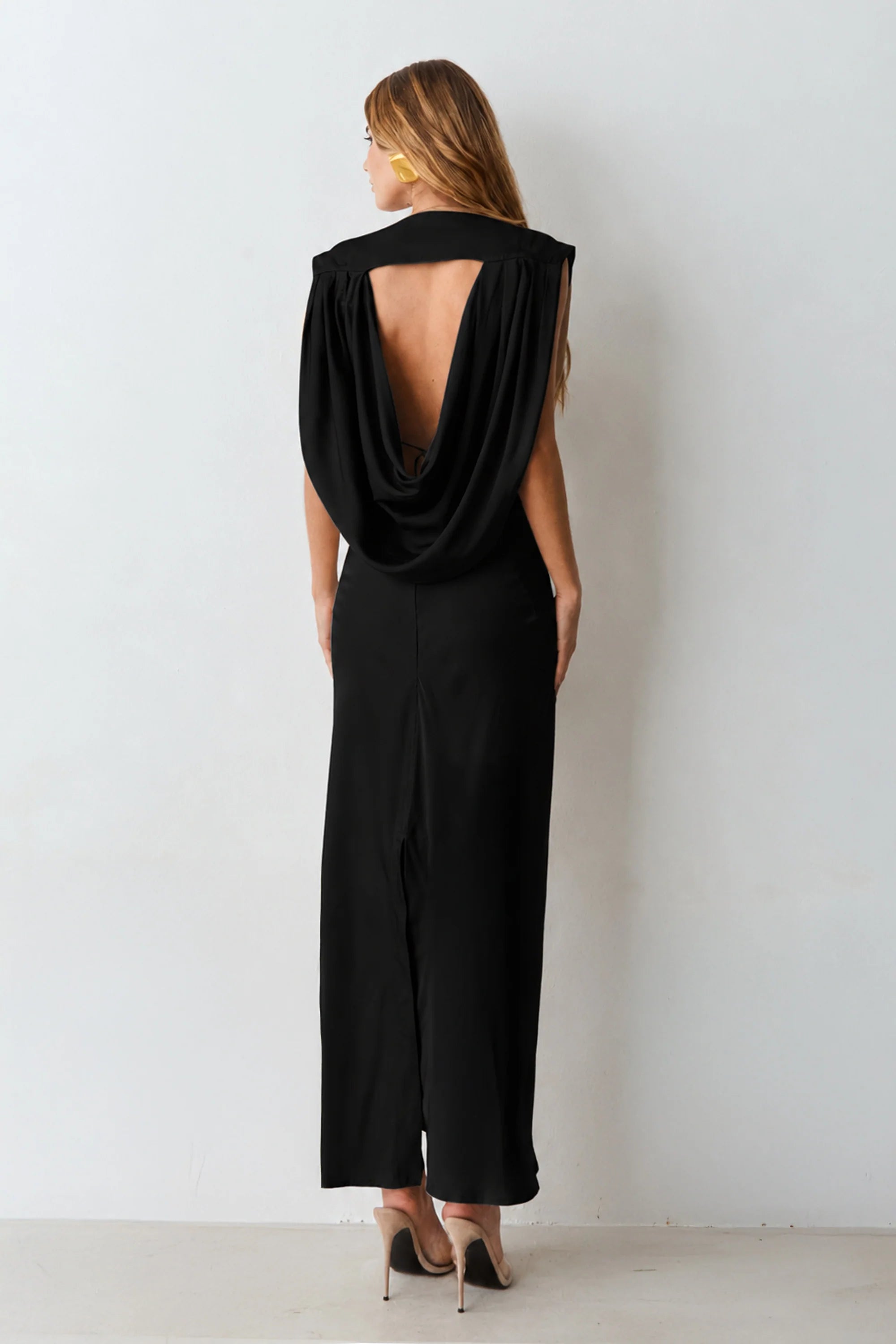 Black V-neck midi dress with shoulder pads and back detailing.
