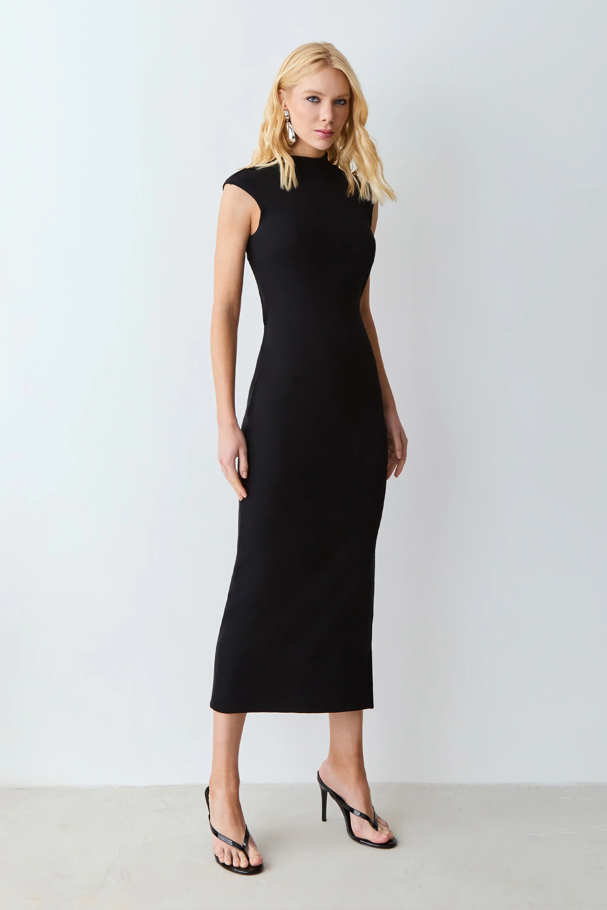 Black midi dress with a medium neckline and a twist-back cutout.